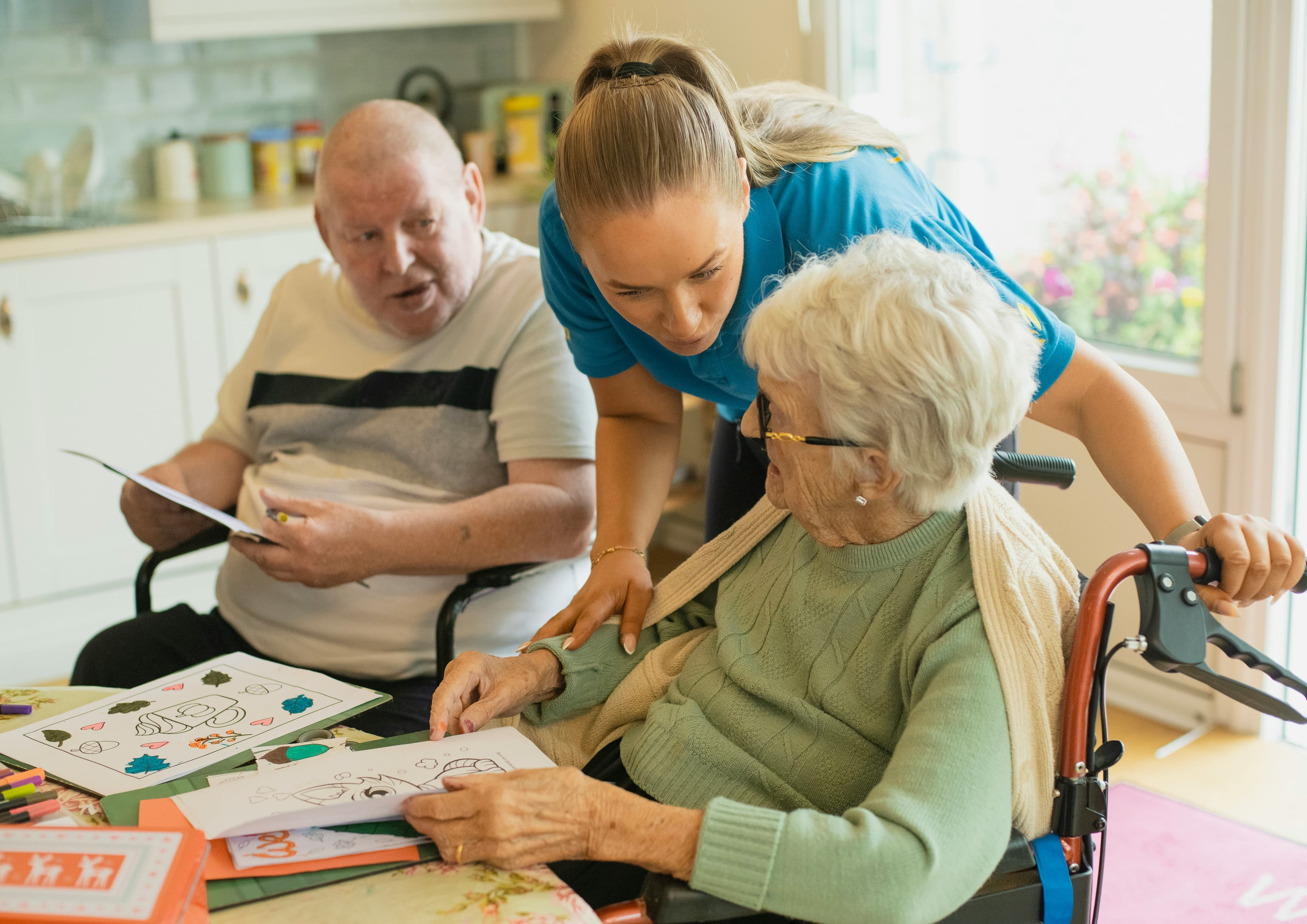 A caregiver assisting an older adult at home