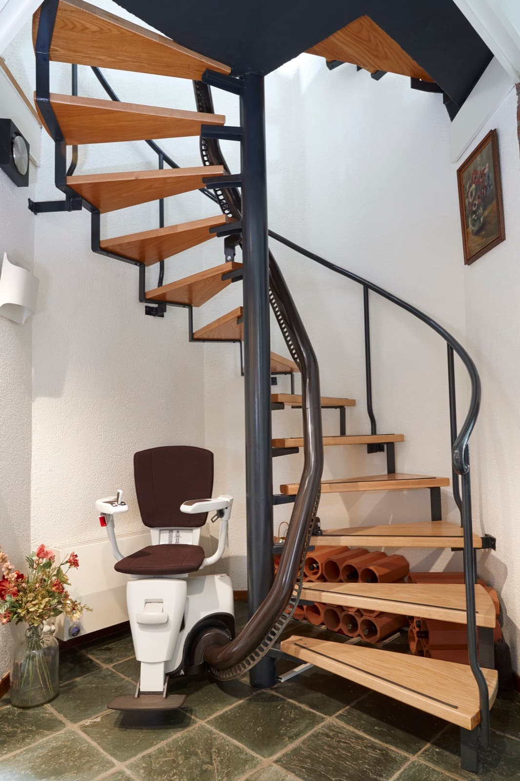 A stairlift fitted to a spiral staircase with a custom curved rail